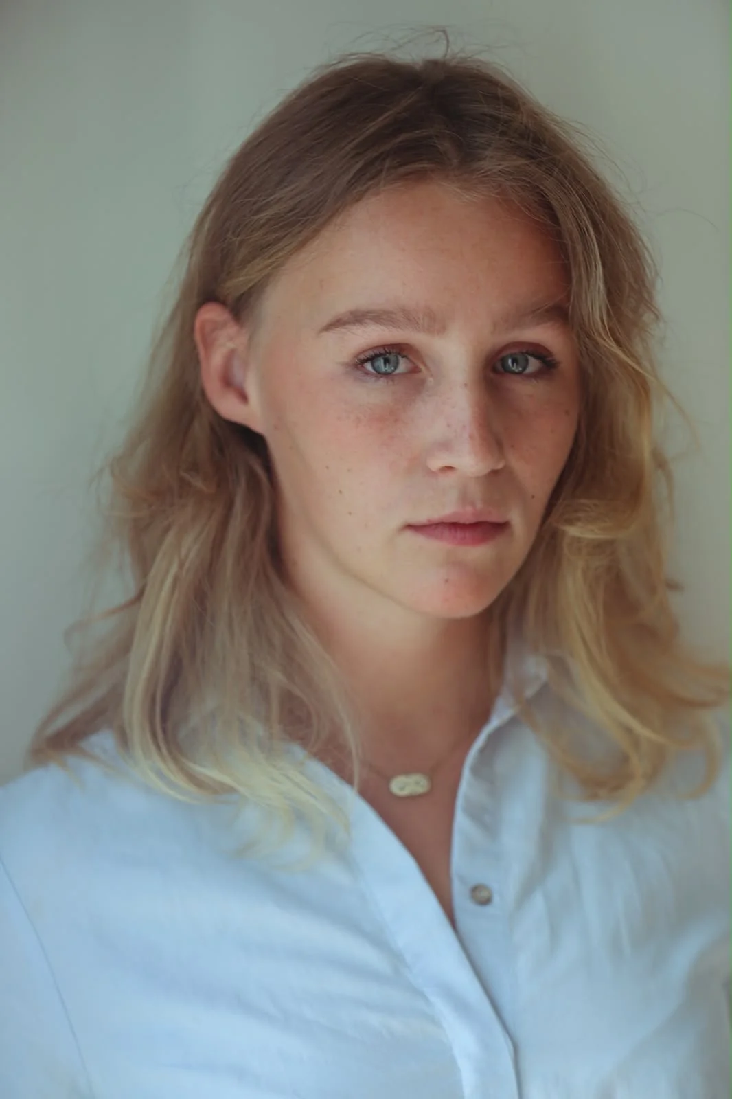 Charlotte Damman wearing a white blouse, casting portrait