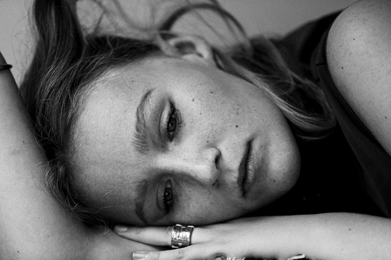 Black-and-white cinematic close-up of Charlotte Damman